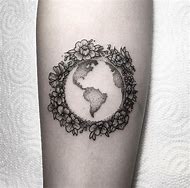 Black shaded earth and fowers tattoo on inner arm