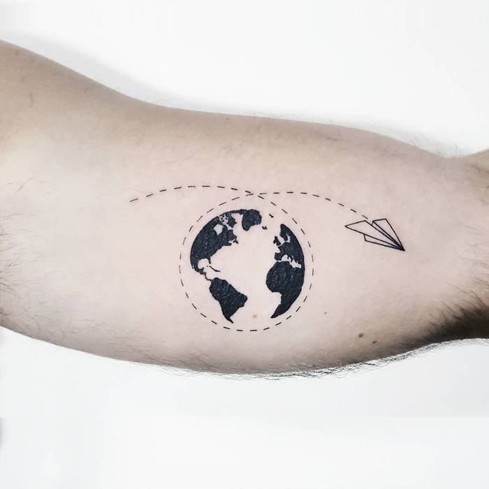 Black shaded earth with airplane tattoo on arm