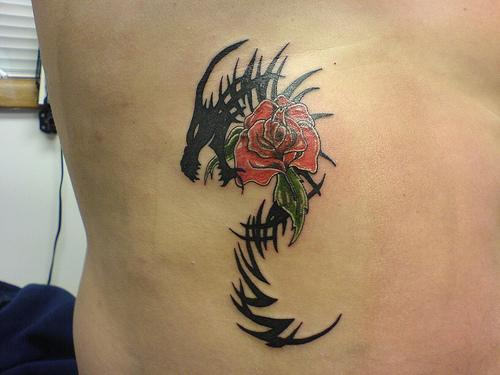 Black tribal dragon rose tattoo on body