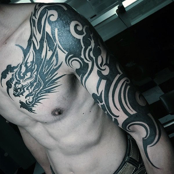 Black tribal dragon tattoo on upper left chest and arm for men