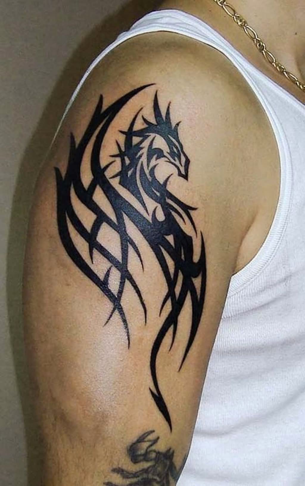 Black tribal dragon tattoo with wings on right arm for men