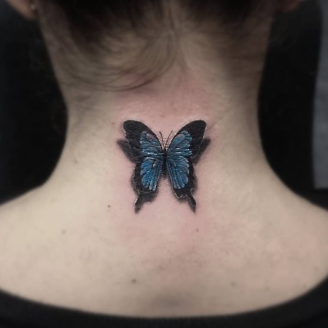Blue and black butterfly tattoo on nape