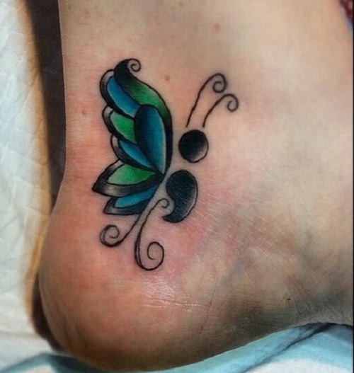 Blue and green butterfly tattoo on foot