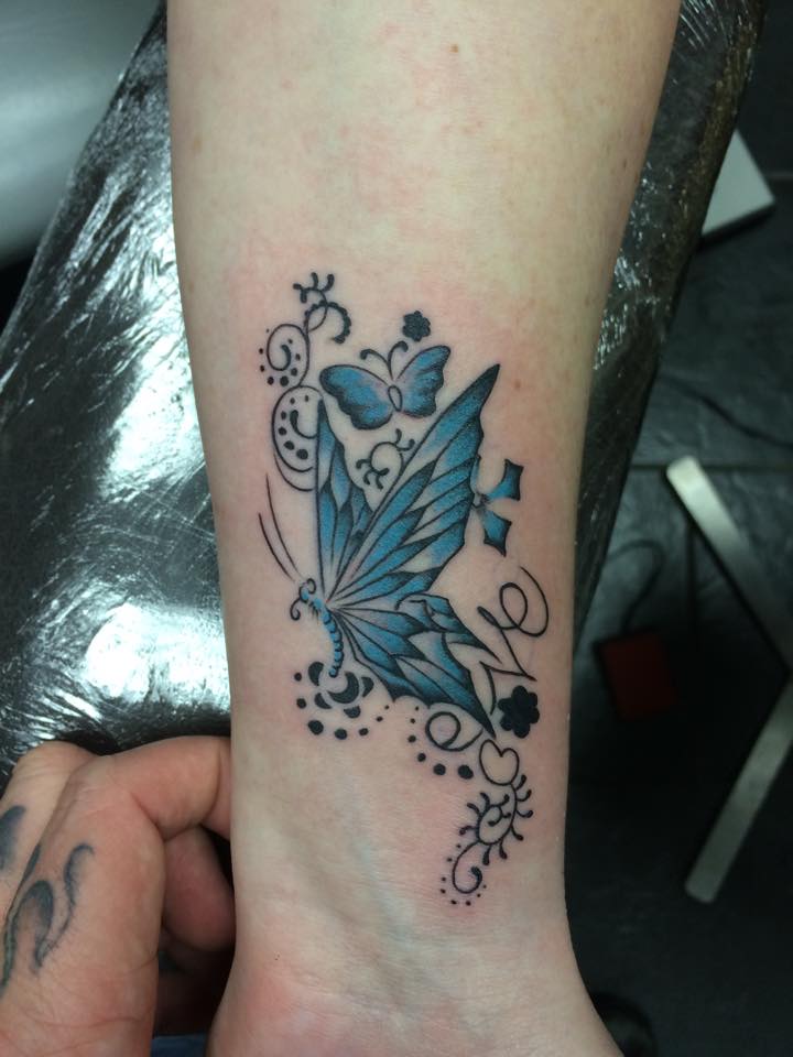 Blue butterfly tattoo design on lower legs