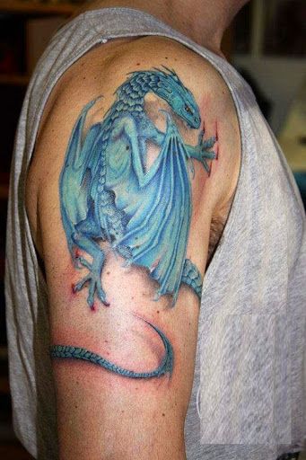 Blue dragon tattoo on right upper arm