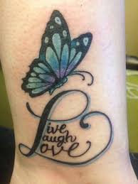 Blue half butterfly with words tattoo on inner arm