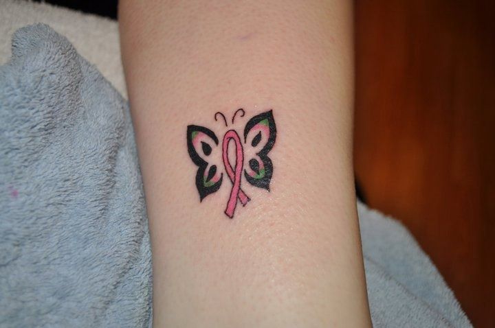 Cancer ribbon butterfly tattoo on inner arm