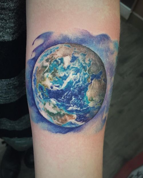 Colored 3d earth tattoo on inner arm