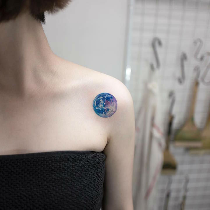 Colored 3d earth tattoo on left front shoulder for women
