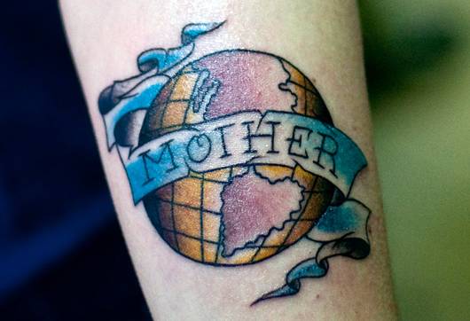 Colored earth mother tattoo on arm