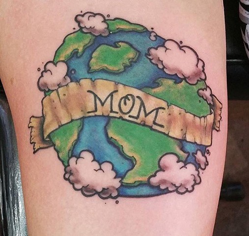 Colored earth mother tattoo on body