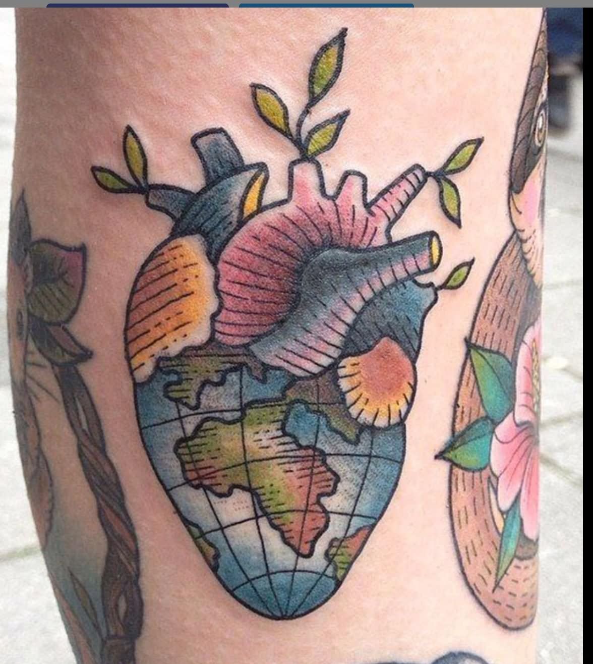 Colored heart with earth tattoo on arm