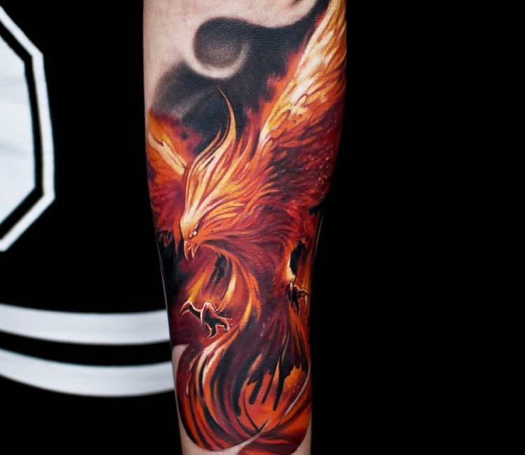 Colored realistic Phoenix tattoo on forearm by Jurgis Mikalauskas