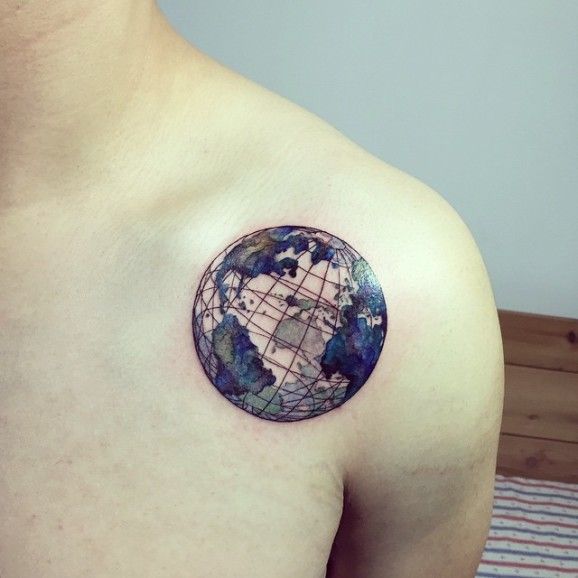Colored shaded grid earth tattoo on upper left front shoulder