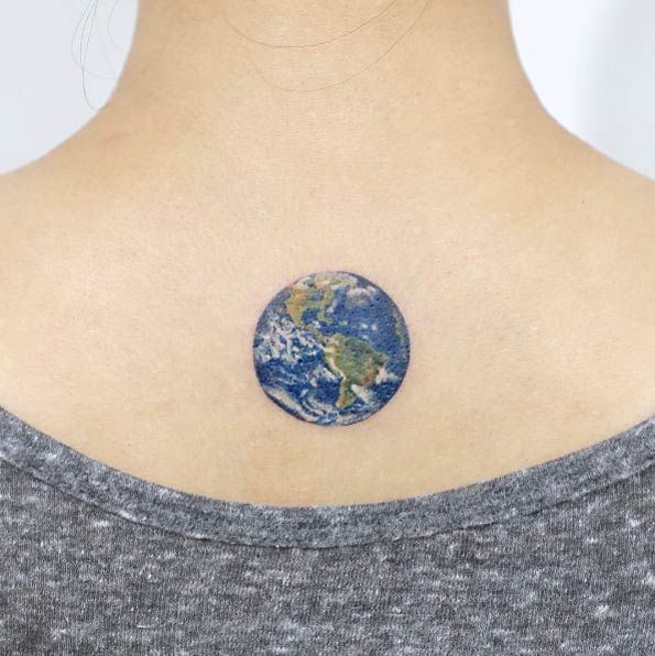 Colored small 3d earth tattoo on upper mid back for women