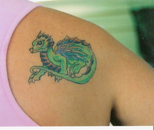 Colored tiny baby dragon tattoo on right upper back shoulder