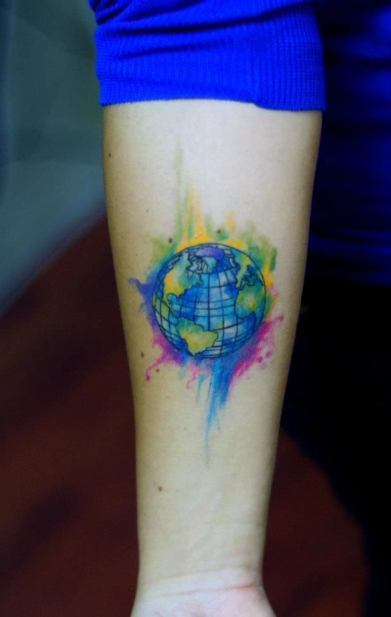 Colored watercolor earth tattoo on inner arm