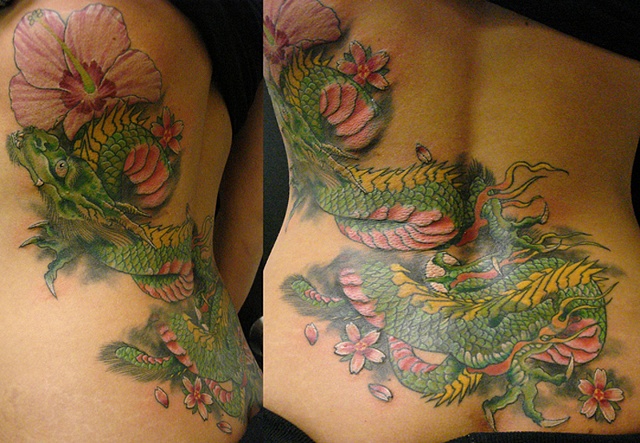 Colorful Tattoo Of Green Dragon and Pink Flowers on Girl’s Back