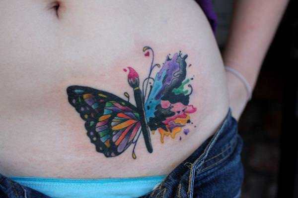 Colorful butterfly tattoo on girl’s left lower waist