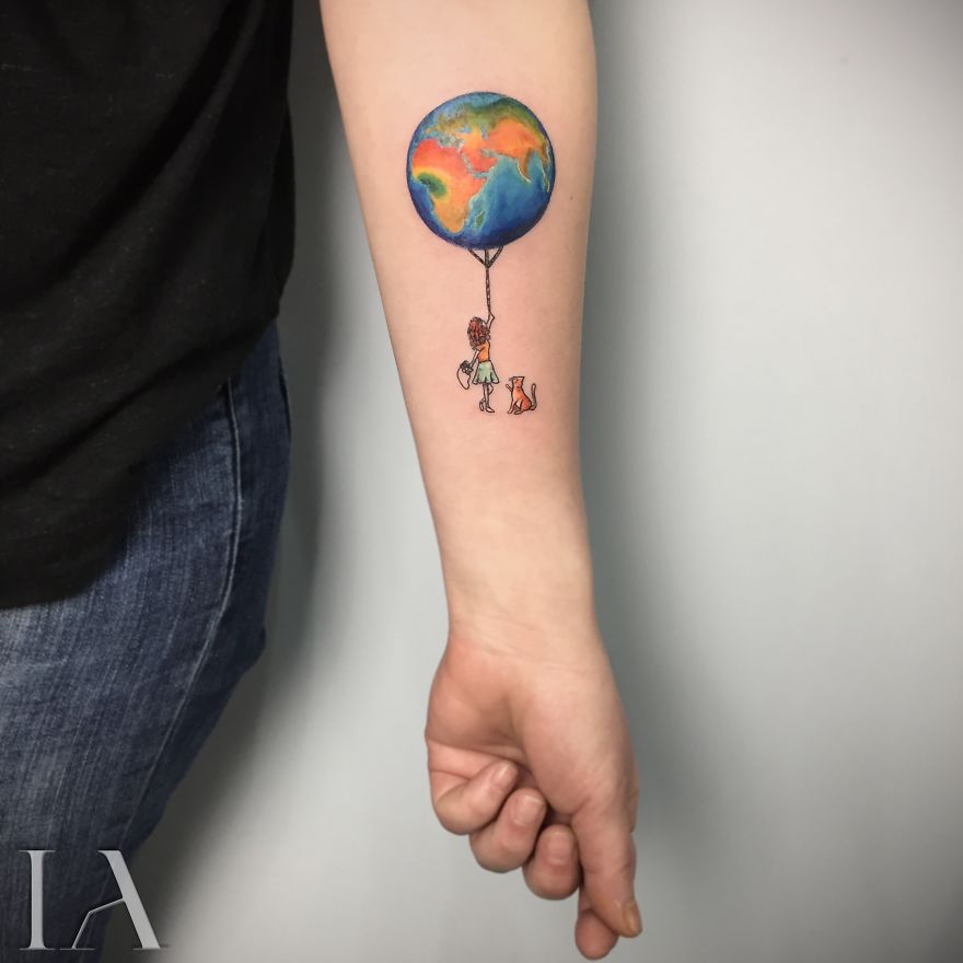 Colorful cute earth balloon tattoo with girl and dog on inner arm