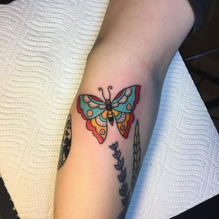 Colorful designer butterfly tattoo on arm