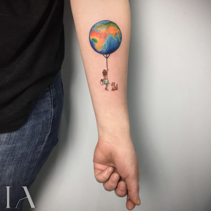 Colorful earth balloon tattoo with girl and dog on inner forearm