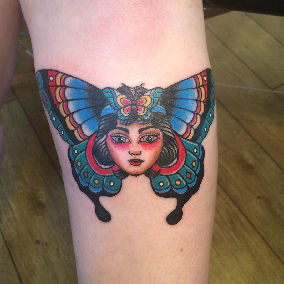 Colorful Japanese butterfly tattoo on inner arm