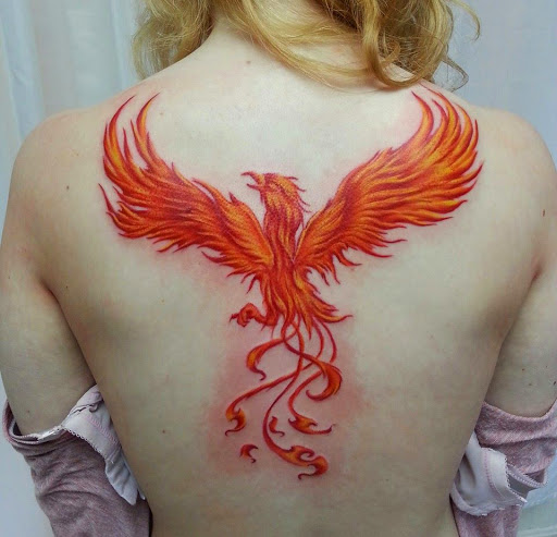 Colorful orange rising phoenix girl back tattoo