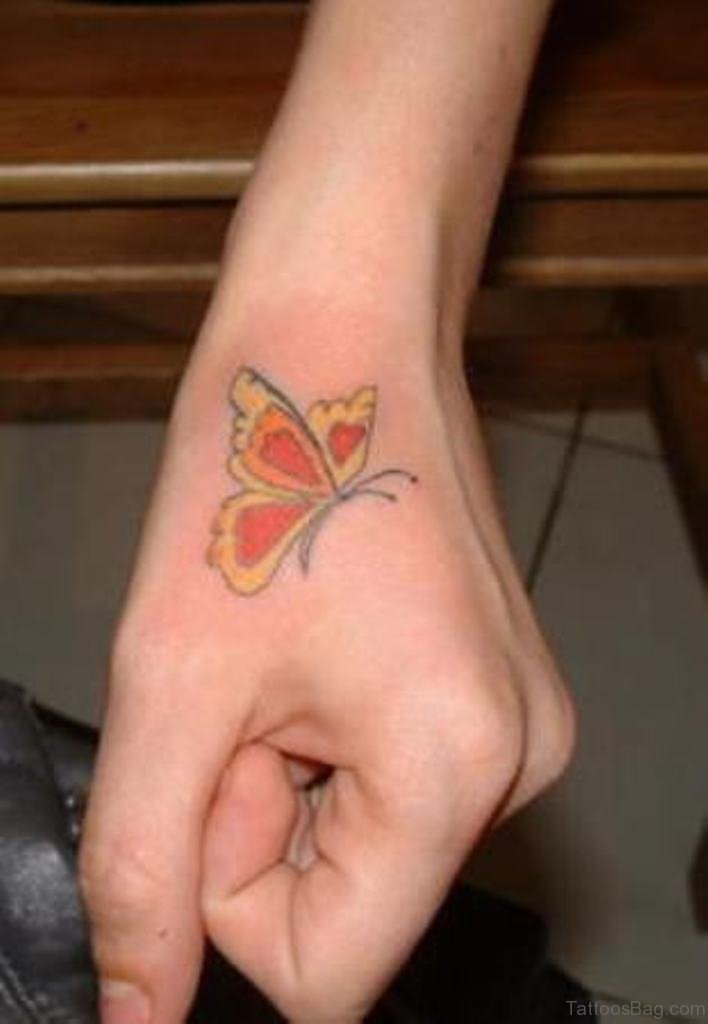 Colorful small butterfly tattoo on hand