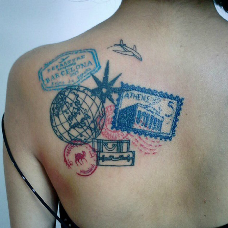 Colored Globe and airplane tattoo with stamp and luggage on left upper back
