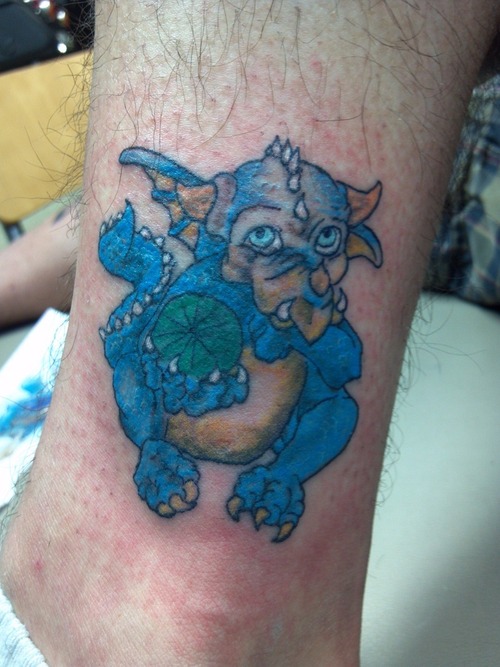 Coloured baby dragon tattoo on leg