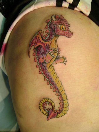 Colored baby dragon tattoo on upper arm