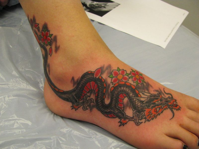 Colored dragon flower tattoo on right foot for women
