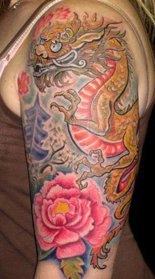Colourful dragon flowers tattoo on upper right arm by Michele Wortman