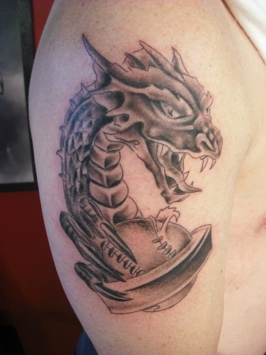 Dragon baseball tattoo on right upper arm