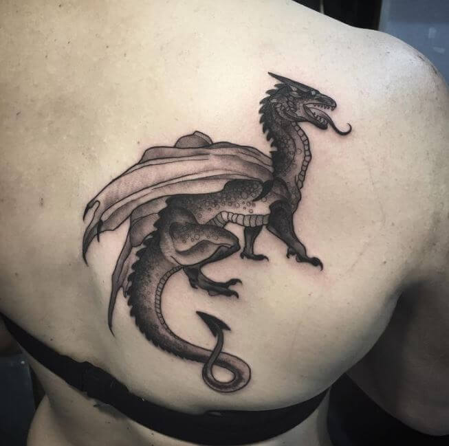 Dragon tattoo on upper right shoulder