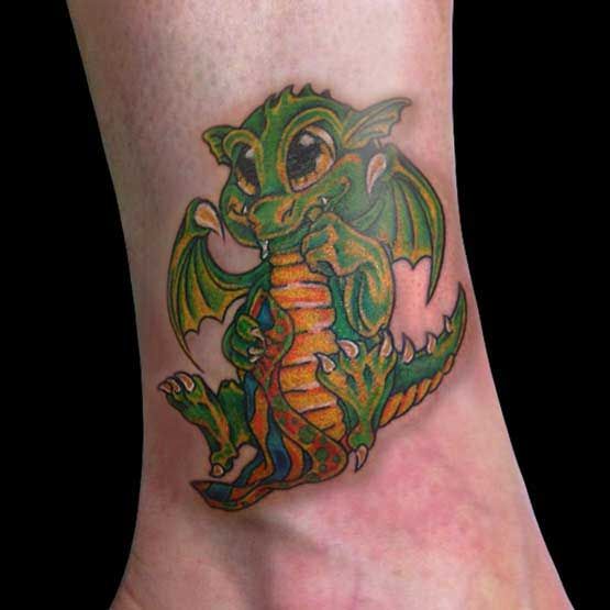 Green and yellow baby dragon tattoo on wrist