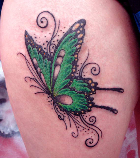Green butterfly tattoo design on biceps