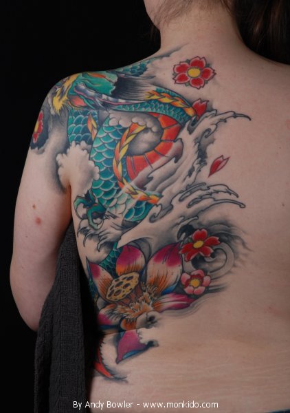 Green dragon and colored flowers tattoo on left back and arm for women