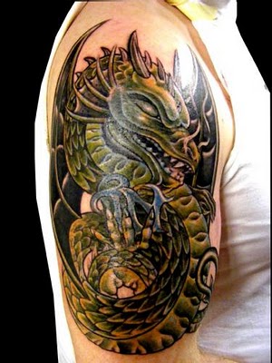 Green dragon snake tattoo on biceps