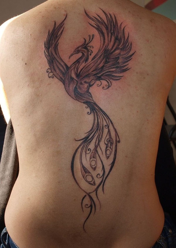 Grey ink flying phoenix tattoo on guy’s back