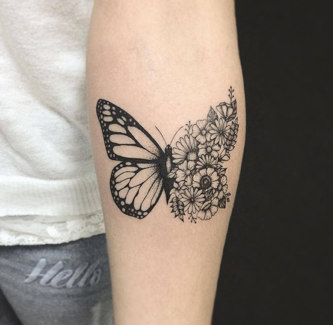 Half Butterfly and flower tattoo on inner arm