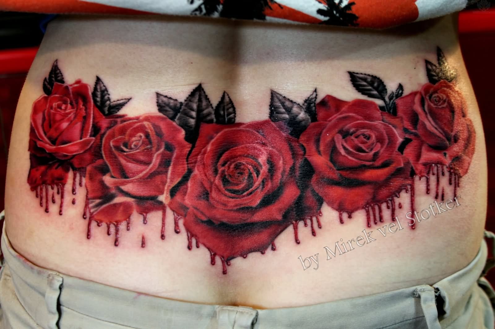Lower back red roses with gray leaves tattoo design for women
