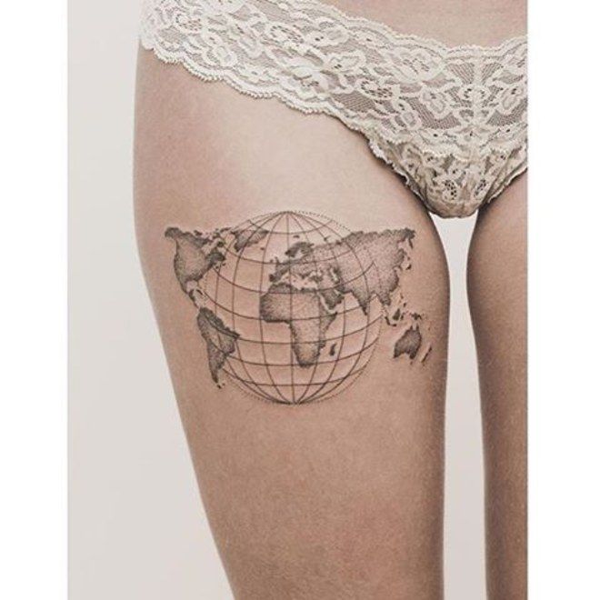 Map with 3-d globe tattoo on right upper thigh