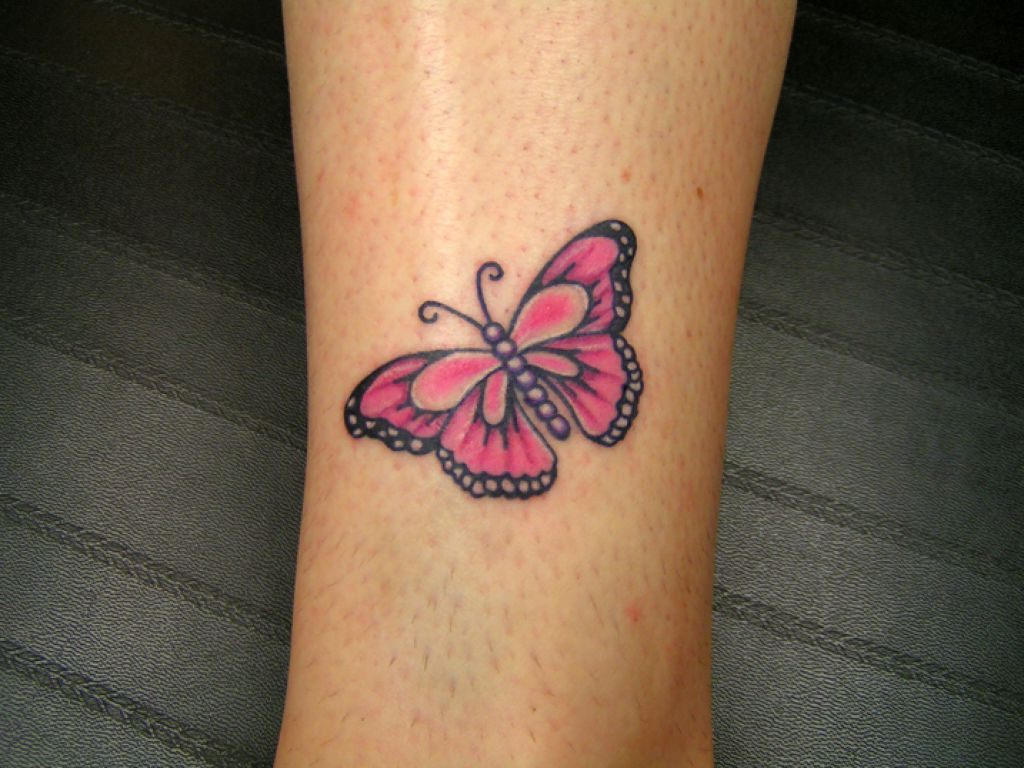 Pink butterfly tattoo on leg