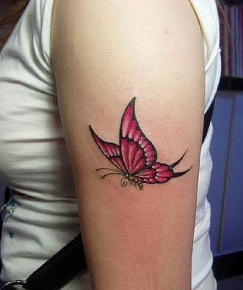 Pink butterfly tattoo on upper arm