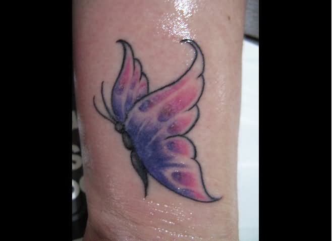 Purple and pink butterfly tattoo on inner arm