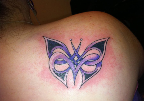 Purple blade butterfly tattoo on back right shoulder