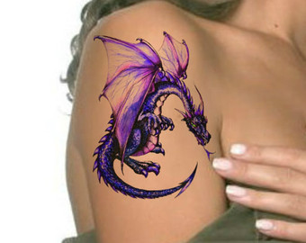 Purple small dragon tattoo on right upper arm of woman