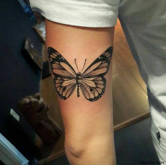 Realistic butterfly tattoo design on upper arm
